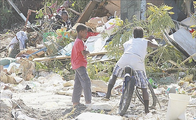 Youngsters picking through the debris on Sunday at the site near Prince Charles Drive after bulldozers moved in last week.
Photos: Tim Clarke/Tribune Staff