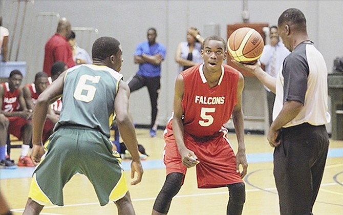 TIP-OFF: Jordan Prince William Falcons senior boys defeated the Queen’s College Comets 44-37 yesterday as the The Bahamas Association of Independent Secondary Schools basketball championship series tipped off in all four divisions at the Kendal Isaacs Gymnasium last night.
                                                                                                                                                                                                 Photo by Tim Clarke/Tribune Staff