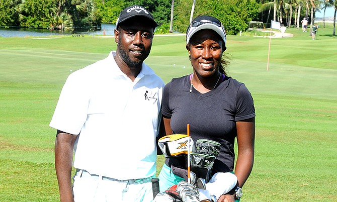 Georgette Rolle takes a photo with her Golf Caddy Ricardo Davis at the Pure Silk-Bahamas LPGA Classic at the Ocean Club Golf Course, Friday.
 (BIS photo/Kemuel Stubbs)
