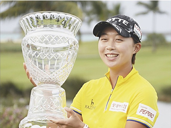 Hyo Joo Kim, winner of the 2016 Pure Silk Bahamas LPGA Classic, shows off her trophy.
Photo by Shawn Hanna/Tribune Staff