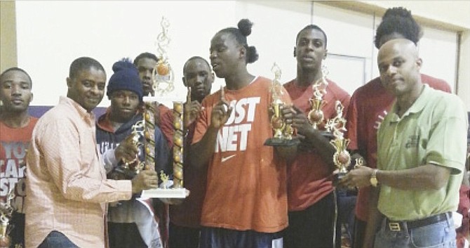WINNERS: St Paul’s Baptist Church basketball team members get their trophies from Pastor Melvin Grant and Rev Lavado Duncanson.