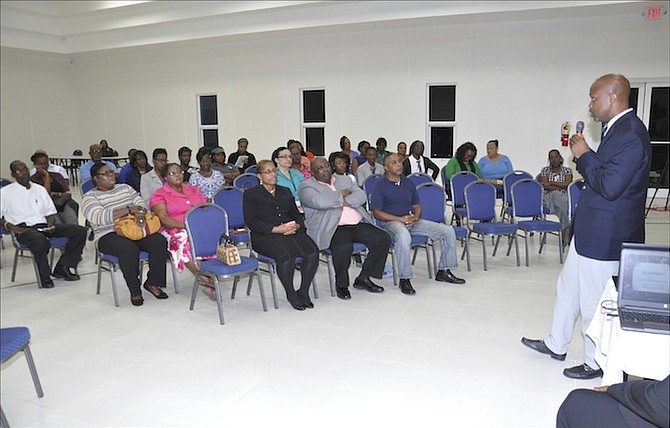 Dr Delon Brennan, National Health Insurance Project Manager, addresses a town meeting at the Bahamas Union of Teachers headquarters in Freeport on Wednesday night. 
Photos: Vandyke Hepburn/BIS

