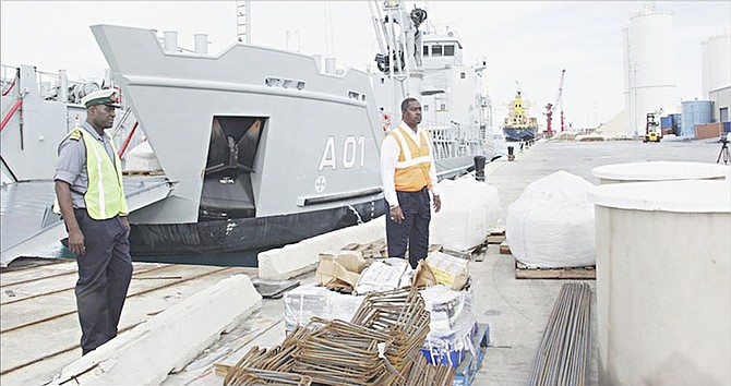 Lt Cmdr Milton Munroe, commanding officer of HMBS Lawrence Major, and Captain Stephen Russell, NEMA director, inspect building materials before their shipment to Hurricane Joaquin impacted islands for rebuilding of homes. Photo: Raymond A Bethel/BIS