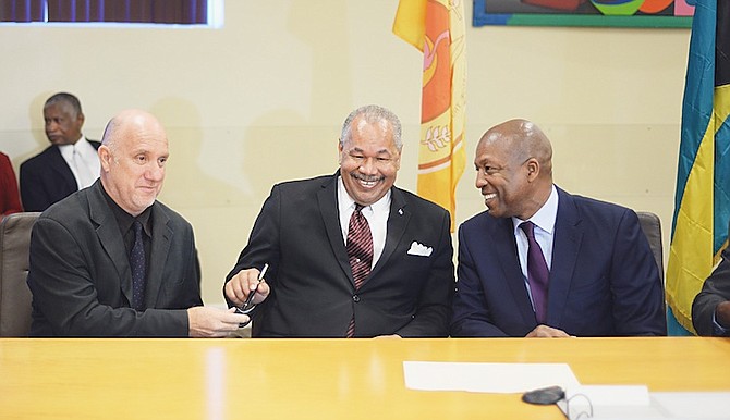 College president Dr Rodney Smith, centre, at the signing of an industrial agreement between COB and the Union of Tertiary Educators yesterday. Photo: Shawn Hanna/Tribune Staff