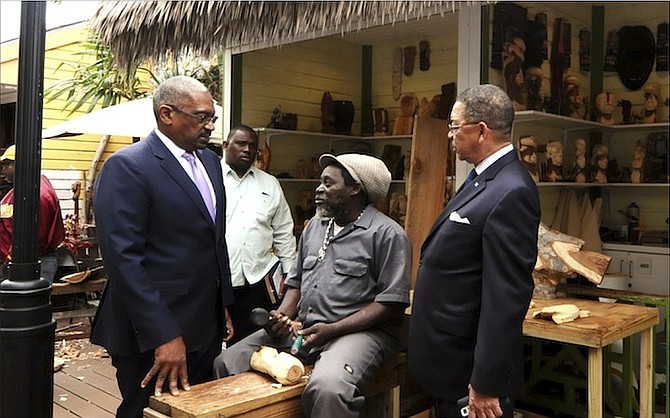 FNM leader Hubert Minnis, left, and MP Hubert Chipman, right, during a visit to the Straw Market. 
Photo: Yontalay Bowe/FNM