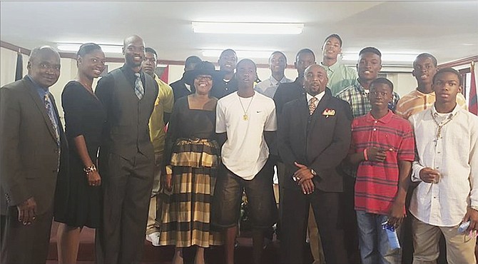 JOB WELL DONE: Doris Johnson Mystic Marlins senior boys’ basketball team celebrate in a church service.