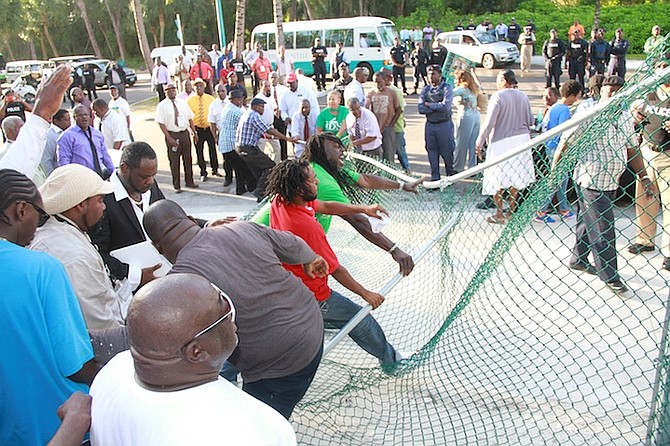Vendors tear down the fence at the Cabbage Beach entrance point on Casino Drive.