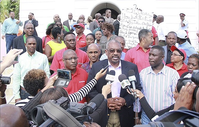 FNM Leader Dr Hubert Minnis speaks to the media outside of court yesterday.
