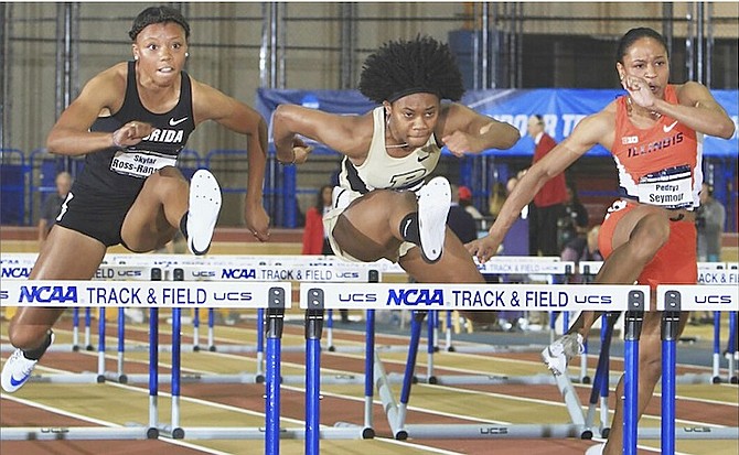 BAHAMIAN hurdlers Devynne Charlton (centre) and Pedrya Seymour (far right) in action over the weekend at the NCAA Indoor Championships in Birmingham, Alabama.
  