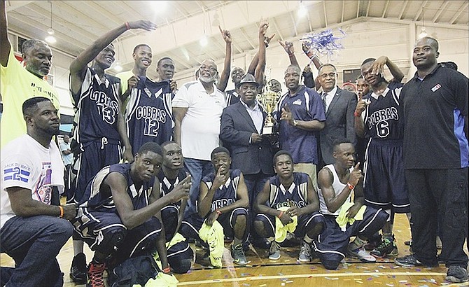 WE ARE THE CHAMPIONS: Deputy Prime Minister Philip Brave Davis celebrates with the CC Sweeting Cobras last night after they won the inaugural National High School Basketball Championship. The Eight Mile Rock Bluejays beat Mary Star of the Sea Crusaders 61-60 to claim the national title in the Family Island Division.   