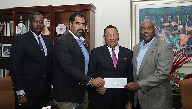 Managing Director of RBC Royal Bank, Bahamas, Cayman and Turks & Caicos Islands, Nathaniel Beneby, right, presents a cheque for $50,000 to Prime Minister Perry Christie, with Director of NEMA Captain Stephen Russell and PriceWaterhouseCoopers Partner and Hurricane Relief Fund Raising Committee Member Gowon Bowe. Photo:Raymond A Bethel/BIS



