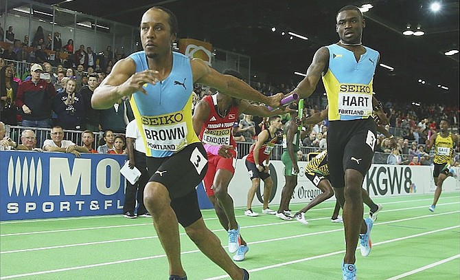 SETTLING FOR SILVER: Shavez Hart passes the baton to Chris Brown yesterday in the men’s 4x400 metres relay final during day four of the IAAF World Indoor Championships at Oregon Convention Center in Portland, Oregon. 
                                                                                                                                                                                            (Photo by Ian Walton/Getty Images for IAAF)
