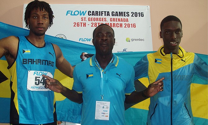 Gold medalist Jyles Etienne and bronze medallist Bejamin Clarke share a moment with coach James Rolle.