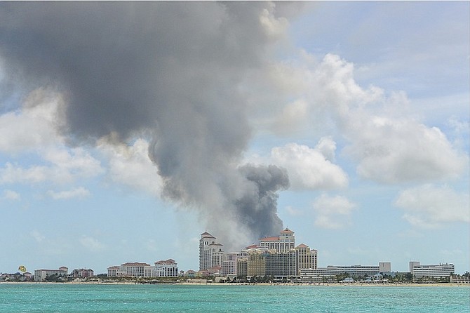 Baha Mar stands in the foreground as a tower of smoke rises behind it after the latest fire at the Harrold Road Landfill. 
Photo: Heather Carey