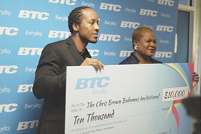 PROUD SPONSOR: Chris Brown receives the $10,000 sponsorship cheque from BTC for the 2nd Chris Brown Bahamas Invitational this Saturday at the Thomas A Robinson National Stadium. At right is Eldri Ferguson-Mackey, BTC vice president of marketing and communications. 
Photo by Shawn Hanna/Tribune Staff