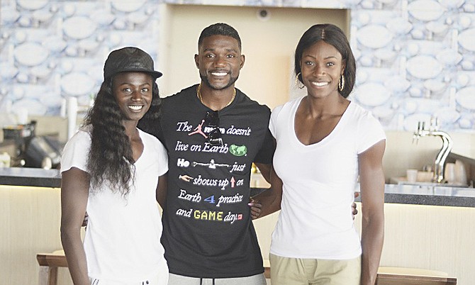 TOUCHING DOWN IN PARADISE: Bahamian quartermiler Shaunae Miller heads a list of world- class athletes who arrived at the Lynden Pindling International Airport yesterday to compete in the 2nd Chris Brown Bahamas Invitational, scheduled to be held on Saturday at the Thomas A Robinson National Stadium. Shown (l-r) at the airport are Tori Bowie, Justin Gatlin and our very own Miller.           
Photo by Shawn Hanna/Tribune Staff