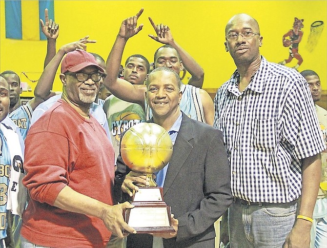 SWEET VICTORY: Cybots head coach Wayde Watson (centre) receives the 2016 New Providence Basketball Association best-of-7 championship trophy from Bahamas Basketball Federation 3rd vice president Keith Smith (left) and NPBA president Eugene Horton (right) at the AF Adderley Gym on Wednesday night. The Mail Boat Cybots closed out the best-of-7 series with a 90-70 win over the Commonwealth Bank Giants in game six. 
Photos by Tim Clarke/Tribune Staff