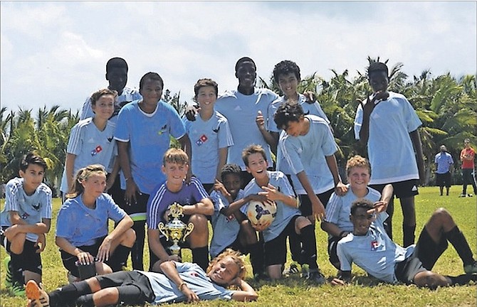 ALL SMILES: The Manta Rays soccer club under-14 boys celebrate their championship victory over Lyford Cay. 