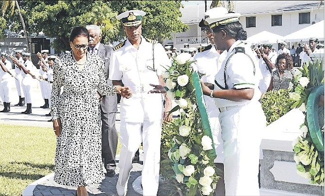 RBDF Acting Commander Tellis Bethel escorts Governor General Dame Marguerite Pindling.