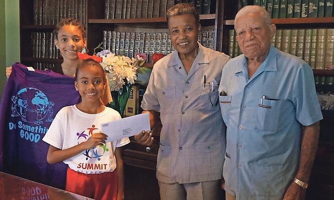 Melissa and Shari Smith donate the profit of their “Do Something Good” T-shirt sales to Pastor Perry Wallace, chairman of the Old Bight Children Home’s executive board (second right), as Pastor Dr William Al McCartney, a former president of the Association of the Assemblies of Brethren in the Bahamas, looks on.