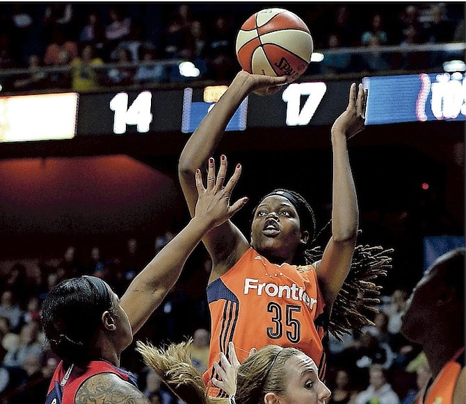 Connecticut Sun’s Jonquel Jones, centre, shoots over Washington Mystics’ Kia Vaughn, left, and Ally Malott during the first half of Saturday’s WNBA game in Uncasville, Connecticut. (AP)
