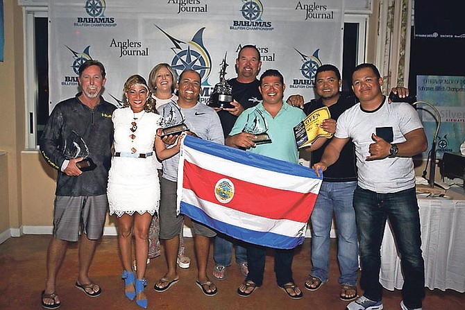 WINNING TEAM: The winning Uno Mas team celebrates victory in the Boat Harbour Championship at Abaco Beach Resort.