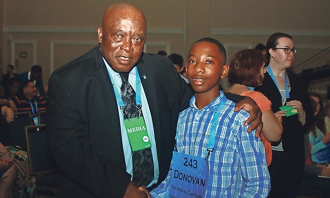 Bahamas National Spelling Bee Champion Donovan Aaron Butler is congratulated by Oswald T Brown after he correctly spelt his third round word at the 2016 Scripps National Spelling Bee on Wednesday. 
Photo: Elisabeth Ann Brown