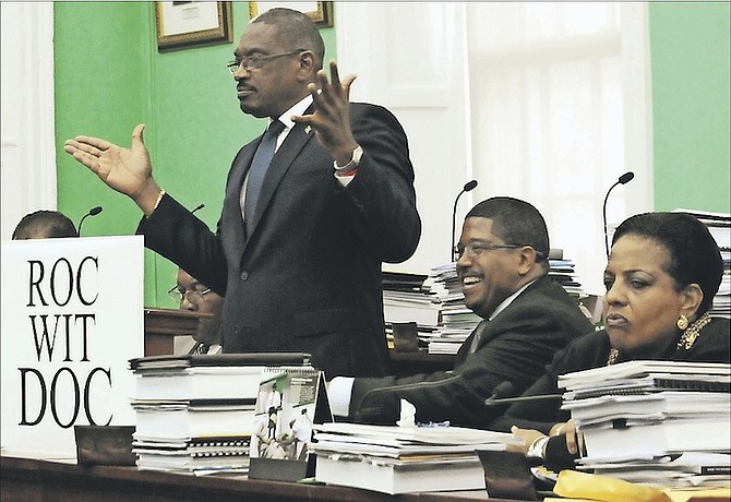 FNM leader Dr Hubert Minnis unveiling his 'Roc Wit Doc' slogan in the House of Assembly, pictured with deputy leader Peter Turnquest and Loretta Butler-Turner, who is to challenge for the leadership at the upcoming convention. Photo: Yontalay Bowe