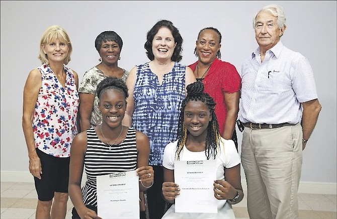 Grand Bahama Performing Arts Society committee members Colleen O’Connor Lewis, Gloria McGlone, Penny Ettinger, Sue McCrea and Christopher Baker pose along with winners Gerniqua Smith and Savannah Anastacia Sawyer. Photo: David Mackey/TheBahamasWeekly.com