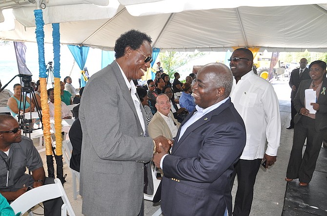 Washington Smith, of Smith’s Construction (left), shakes hands with Deputy Prime Minister Philip 'Brave' Davis on Friday at the signing of a $4.8m contract to build a seawall at Smith's Point, Grand Bahama. Photo: Vandyke Hepburn/BIS