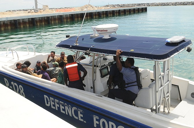 The 14 Cuban migrants arrive at Coral Harbour Base aboard Defence Force patrol craft P-128 on Saturday afternoon. Photo: Petty Officer Jonathan Rolle/RBDF
