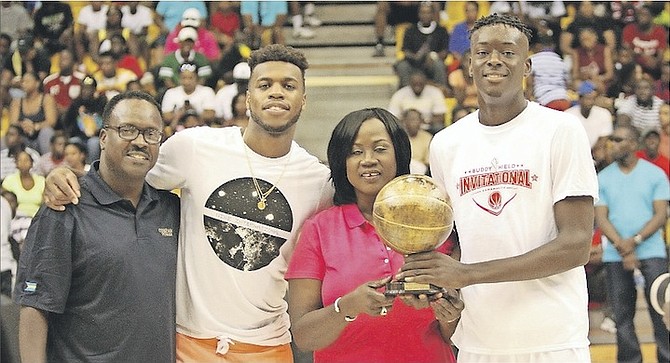 The Buddy Hield Basketball Invitational took place at Kendal G.L. Isaacs Gym on Saturday. Shown (l-r) are Minister of Youth, Sports and Culture Daniel Johnson with Buddy Hield and the Slam Dunk champion.
Photo by Patrick Hanna/BIS
