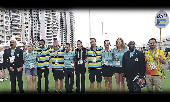 TEAM BAHAMAS: Bahamian swimming and rowing team with Chef de Mission Roy Colebrooke (second from right) and BOC President Wellington Miller (far left) at the flag raising ceremony for our Olympic team in the Games Village.