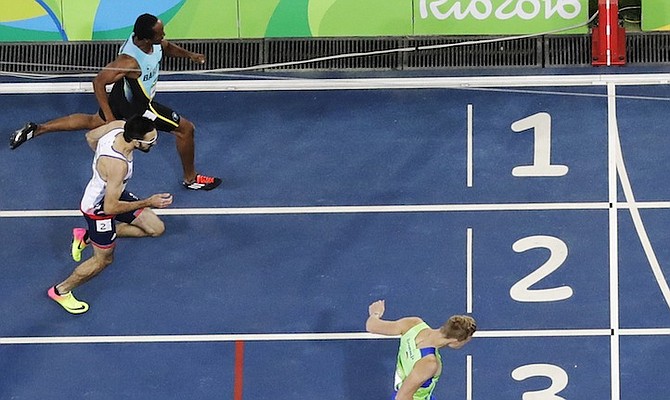 Chris Brown (top) finishes his 400m heat. (AP)