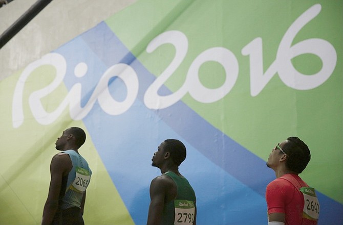Bahamas' Steven Gardiner, Nigeria's Orukpe Eraiyokan and Japan's Yuzo Kanemaru enter the stadium to compete in a men's 400-metre heat during the athletics competitions of the 2016 Summer Olympics at the Olympic stadium in Rio de Janeiro, Brazil. (AP)