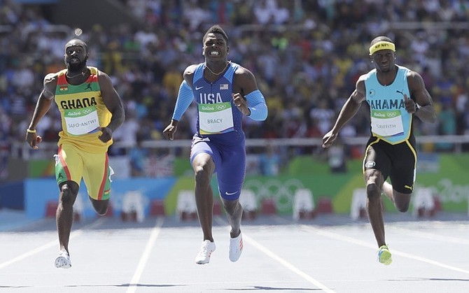 Adrian Griffith in action (right) in the men's 100m heats. (AP)