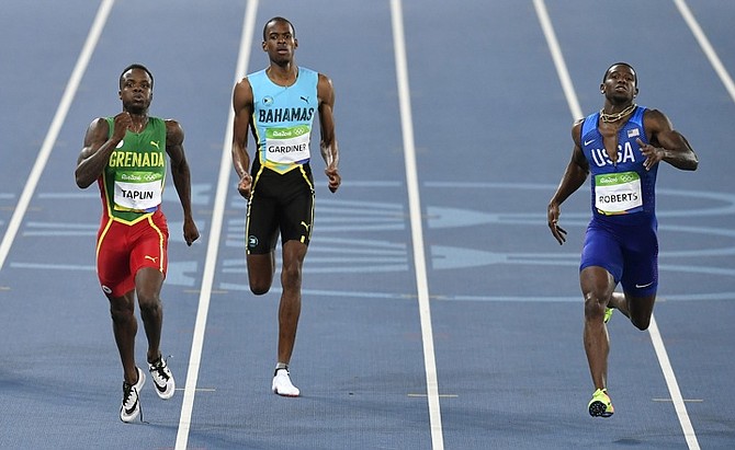 Grenada's Bralon Taplin, left, Bahamas' Steven Gardiner and United States' Gil Roberts, right, compete in a men's 400-metre semifinal during the athletics competitions of the 2016 Summer Olympics at the Olympic stadium in Rio de Janeiro, Brazil, Saturday, Aug. 13, 2016. (AP Photo/Martin Meissner)
