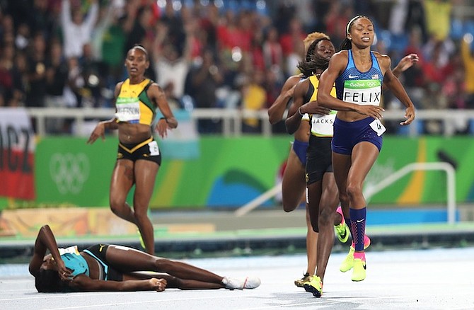 Shaunae Miller on the ground after winning the 400m final. (AP)