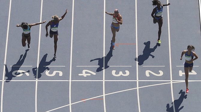 Tynia Gaither (left) finishes third to qualify for the 200m semifinals. (AP)