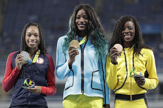 Gold medalist Shaunae Miller, centre, silver medalist Allyson Felix of the USA, left, and bronze medalist Shericka Jackson of Jamaica hold their 400m medals in Rio. (AP)