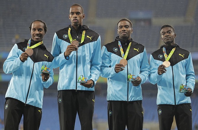 The Bahamas 4x400m relay team with their bronze medals. (AP)