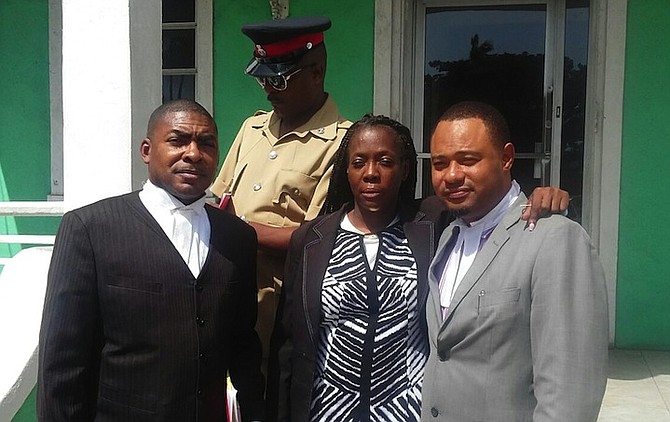 Maria Daxon with her legal representatives Wilver Deleveaux and Glendon Rolle outside the Central Police Station on Friday