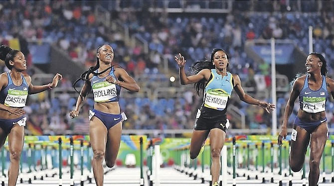 Pedrya SEYMOUR, second from right, of the Bahamas, finished sixth overall in the 100 metre hurdles at the Rio Olympics. The Americans pulled off a 1st, 2nd and 3rd place sweep at the Olympic stadium in Rio de Janeiro, Brazil, last month. (AP)