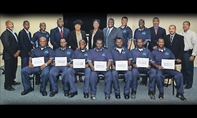 Pictured sitting are successful participants of the Nassau Airport Development Company Ltd. Maintenance Promotion Assessment Programme who were recently promoted. From left, Harry Gelin; Bradley Johnson; Antoine Brown-McKenzie; Ramon Rolle; Roberto Graham; Jeno Stuart; and Kendrick King. Not pictured are: Shawn Miller and Rashad Strachan. Standing, NAD’s Maintenance and Engineering management team that created the metrics for evaluation and invested the time to train and assess the successful candidates along with Gary Scavella, director, maintenance and engineering (4th from left); Vernice Walkine, president and CEO (5th from left); Sian Bevans, director, human resources and Kevin McDonald, vice-president, maintenance and engineering (6th from left).