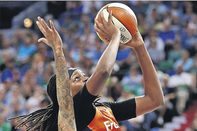 Connecticut Sun’s Jonquel Jones, of the Bahamas, goes for a basket after being fouled by Minnesota Lynx’s Seimone Augustus (33) during the first half of Sunday’s WNBA game in Minneapolis. 
(AP Photo/Stacy Bengs)