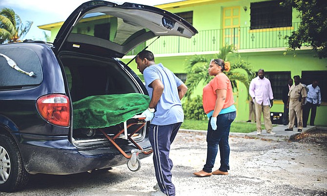 The body of Marisha Bowen is removed from the scene on Friday.
Photo: Shawn Hanna/Tribune staff