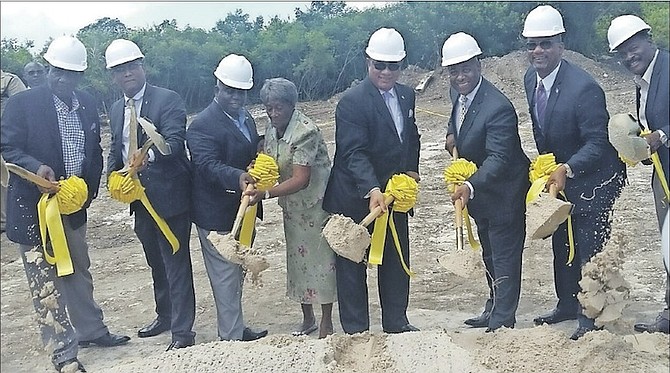 Prime Minister Perry Christie helps to dig the first shovel full of dirt at the ground breaking ceremony for a new junior high school in Holmes Rock, Grand Bahama. 