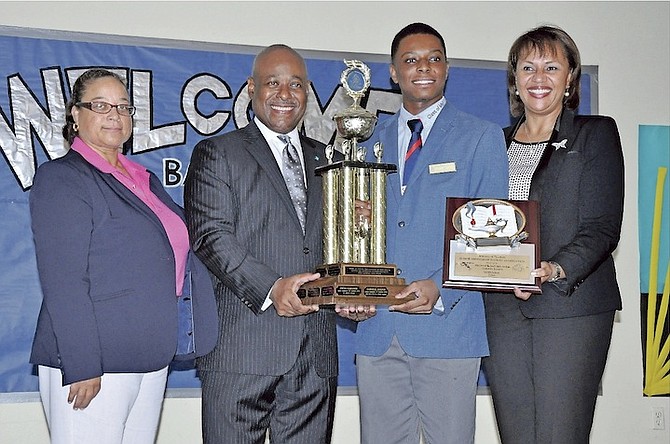 Minister of Tourism Obie Wilchcombe presented the Junior Minister of Tourism, Gabriele Josephs of Mary Star of the Sea Catholic Academy, with a trophy and plaque during a school Special Assembly, watched by principal Joy Ritchie-Greene, left, and ministry director general Joy Jibrilu.  
Photo: Vandyke Hepburn/BIS