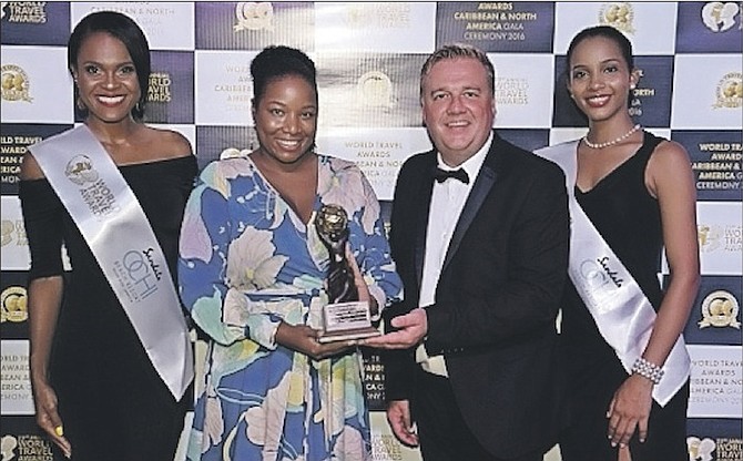 Lonise Carey, managing director, Island Destination Services, accepts the 2016 World Travel Award in Jamaica on Saturday.