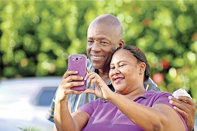 A young lady who works at Creative Hands, a breakfast and bakery café in Treasure Cay, Abaco, takes a selfie with Alfred Sears during his recent visit to the island. 